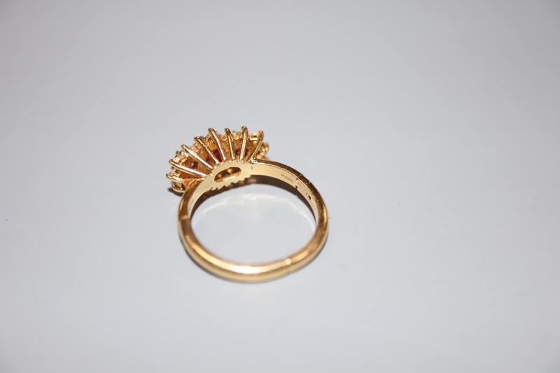 A modern yellow metal, ruby and diamond set triple cluster ring, with expanding shank, size 0-R, gross weight 5 grams.